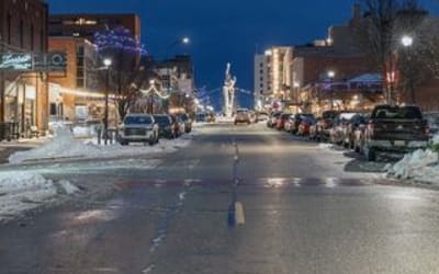 Street in the winter at night with holiday and street lights