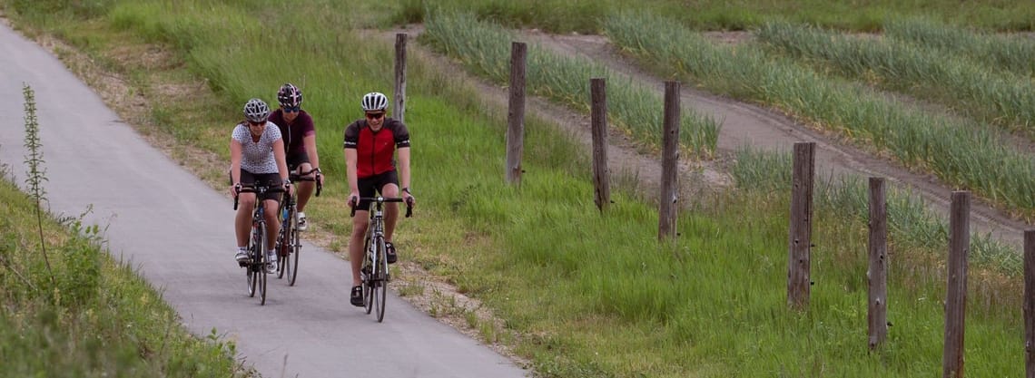 Cyclists on the Salmon River Parallel Trail.