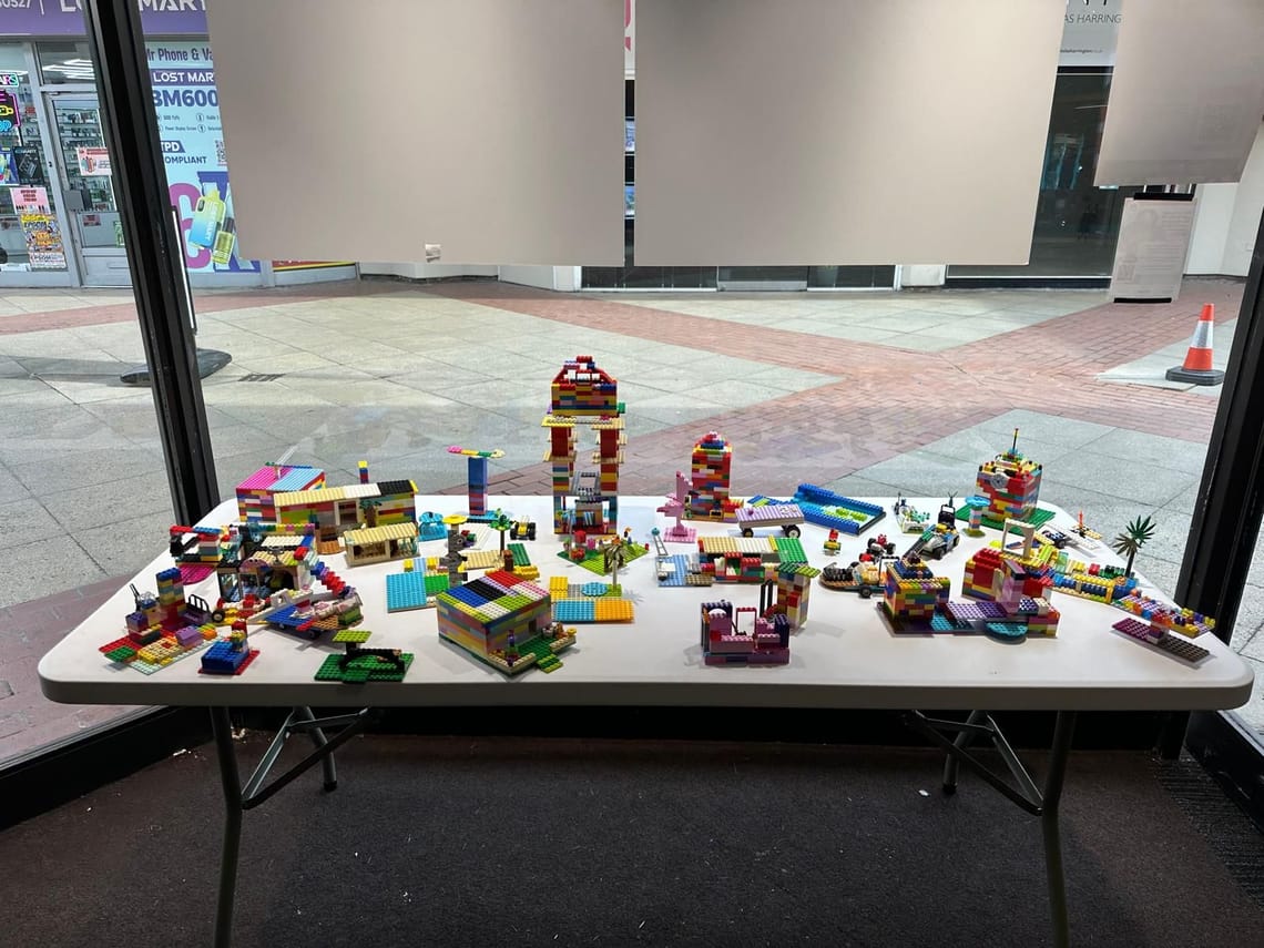 A collection of bright toy brick constructions on a table