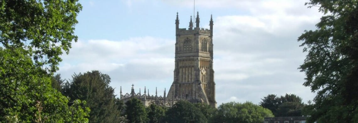 Image of Cirencester Church with trees
