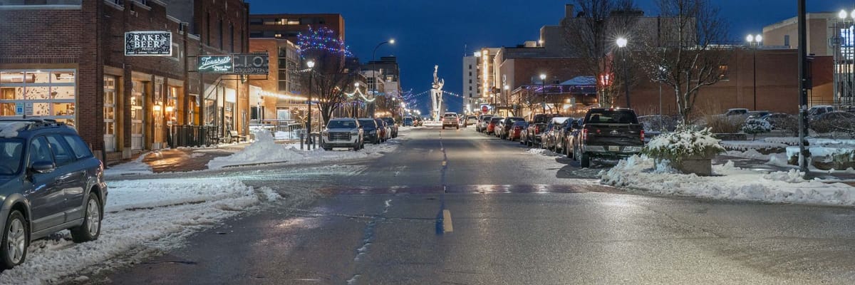 Street in the winter at night with holiday and street lights