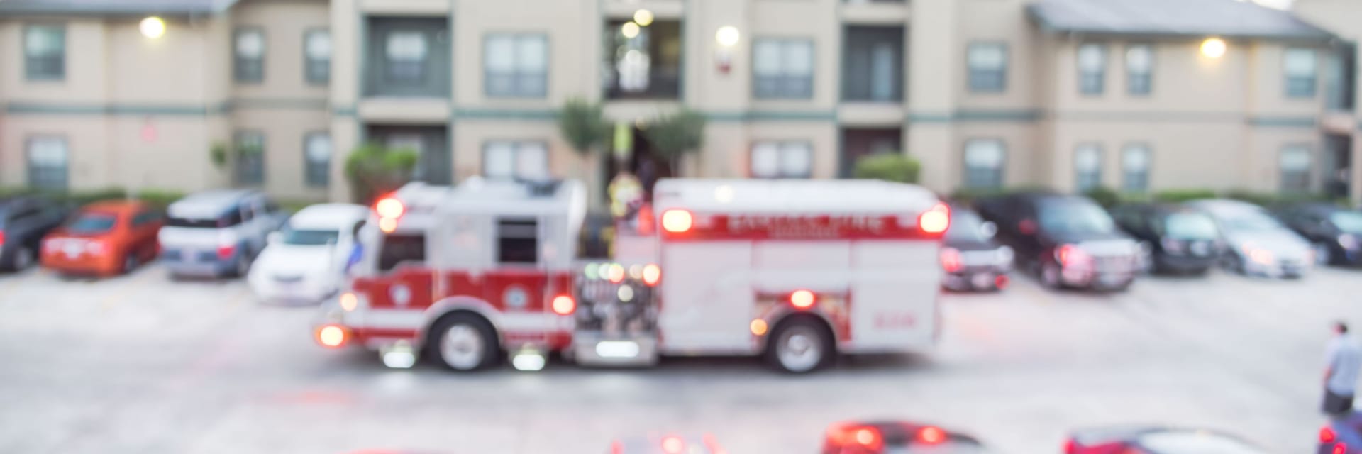 Blurred photo Fire truck in front of apartment building