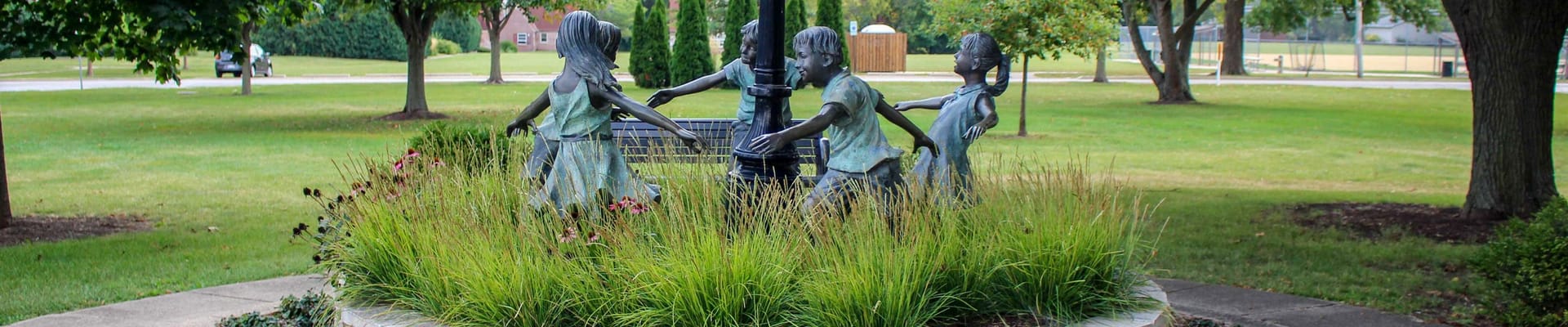 Sculpture of children playing ring around the rosy l