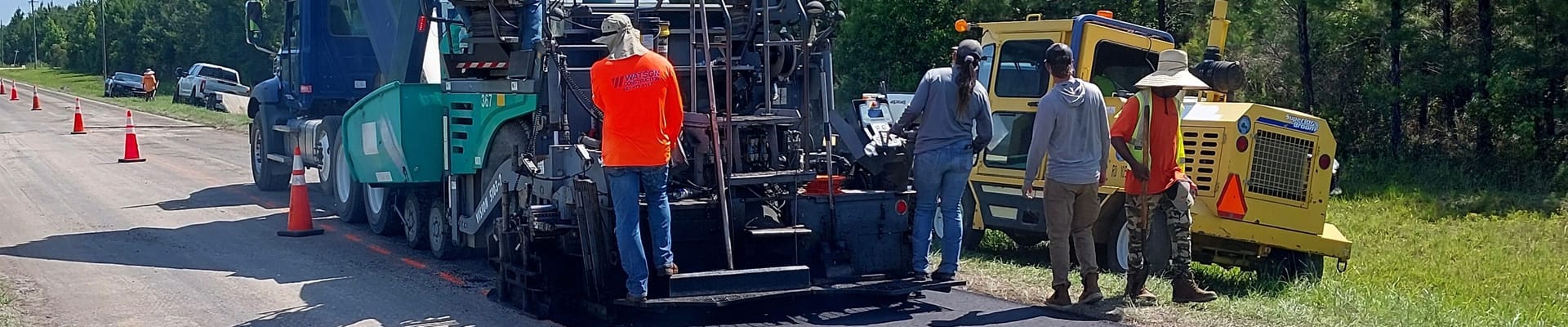 Construction workers paving road
