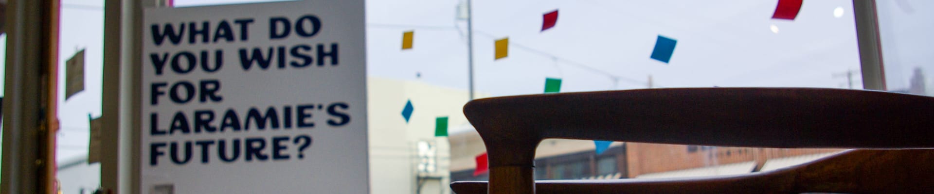Colorful interior scene featuring a sign that reads, “What do you wish for Laramie’s future?