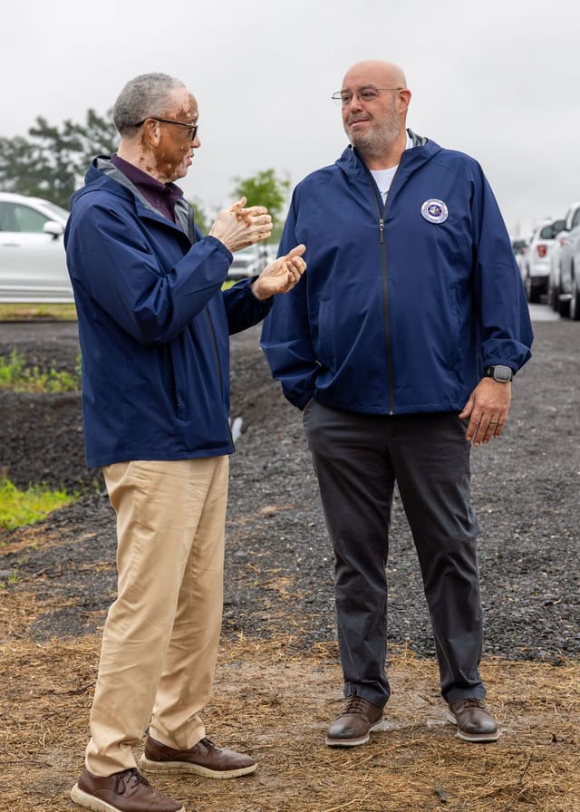 2 men converse after ceremony
