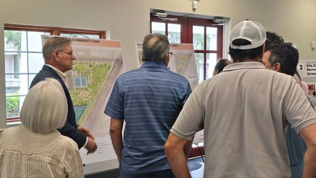 Image of attendees looking at new design