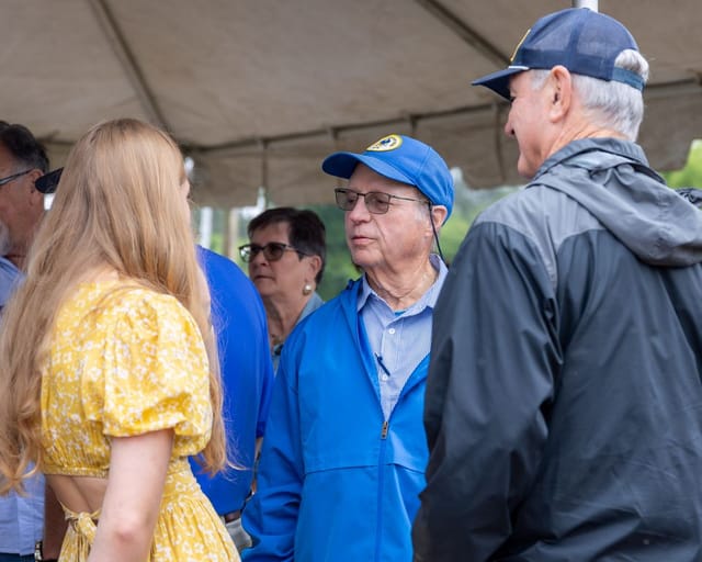 citizens converse under the tent after the ceremony
