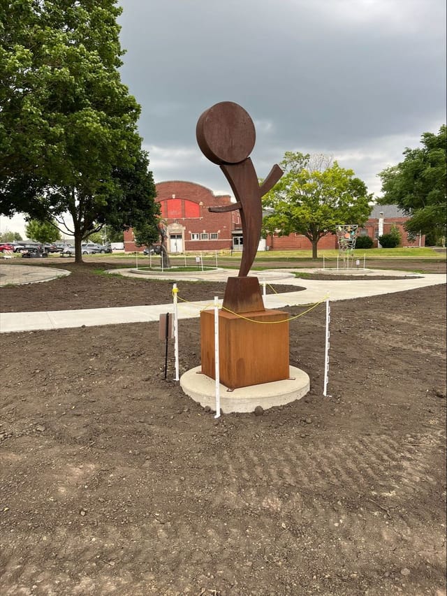 6’ tall carbon steel sculpture on a 3’ base, the gleeful piece mimics an enthusiastic person with raised arms