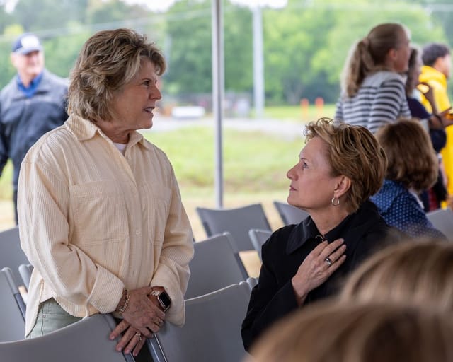 citizens converse under the tent after the ceremony
