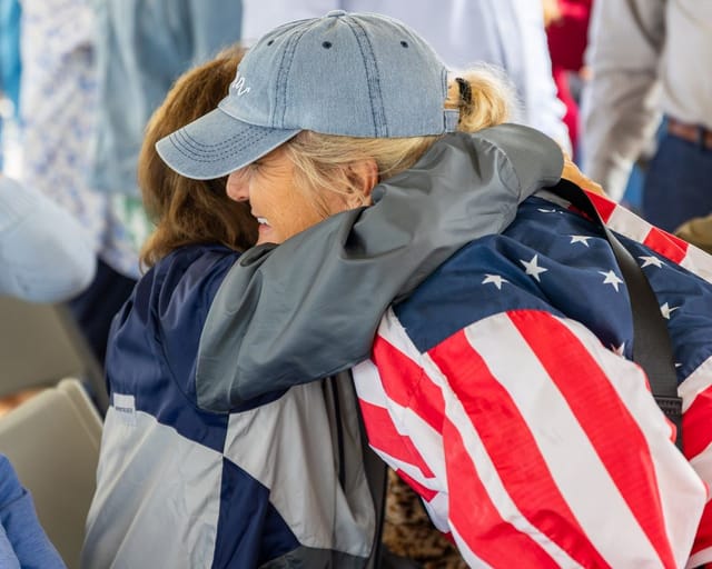 citizens converse under the tent after the ceremony