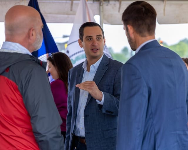 citizens converse under the tent after the ceremony
