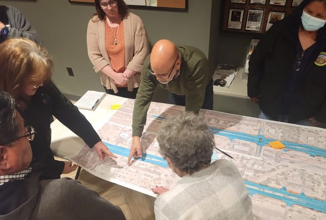 People reviewing the Valencia project map