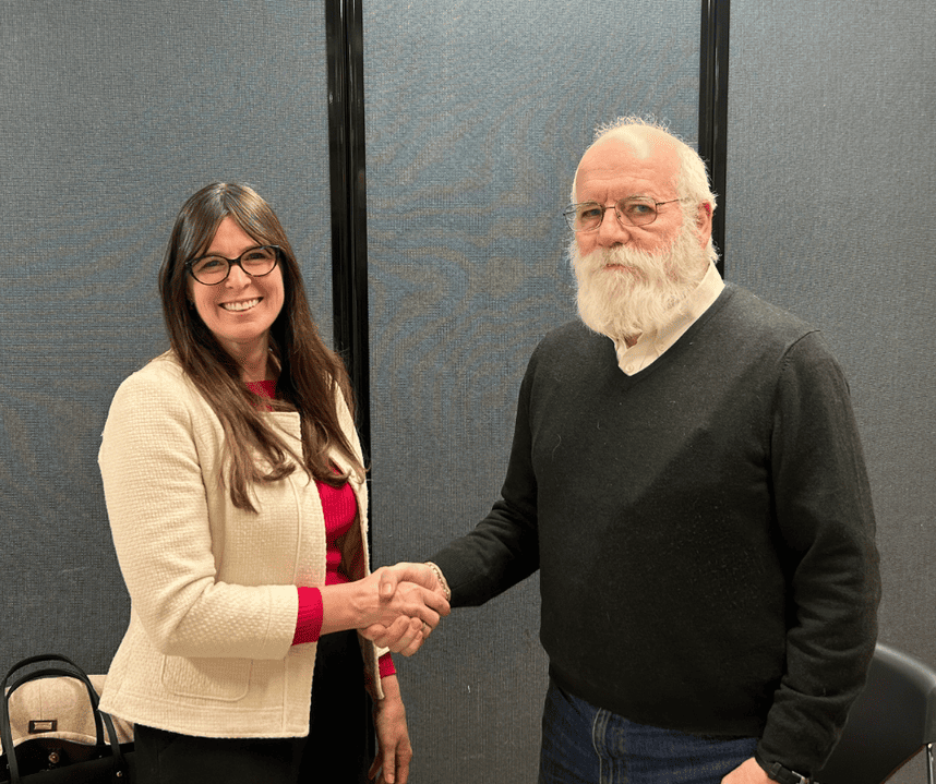 Kelly McNicholas Kury (left) shakes hands with Mayor Jack McCullough (right)