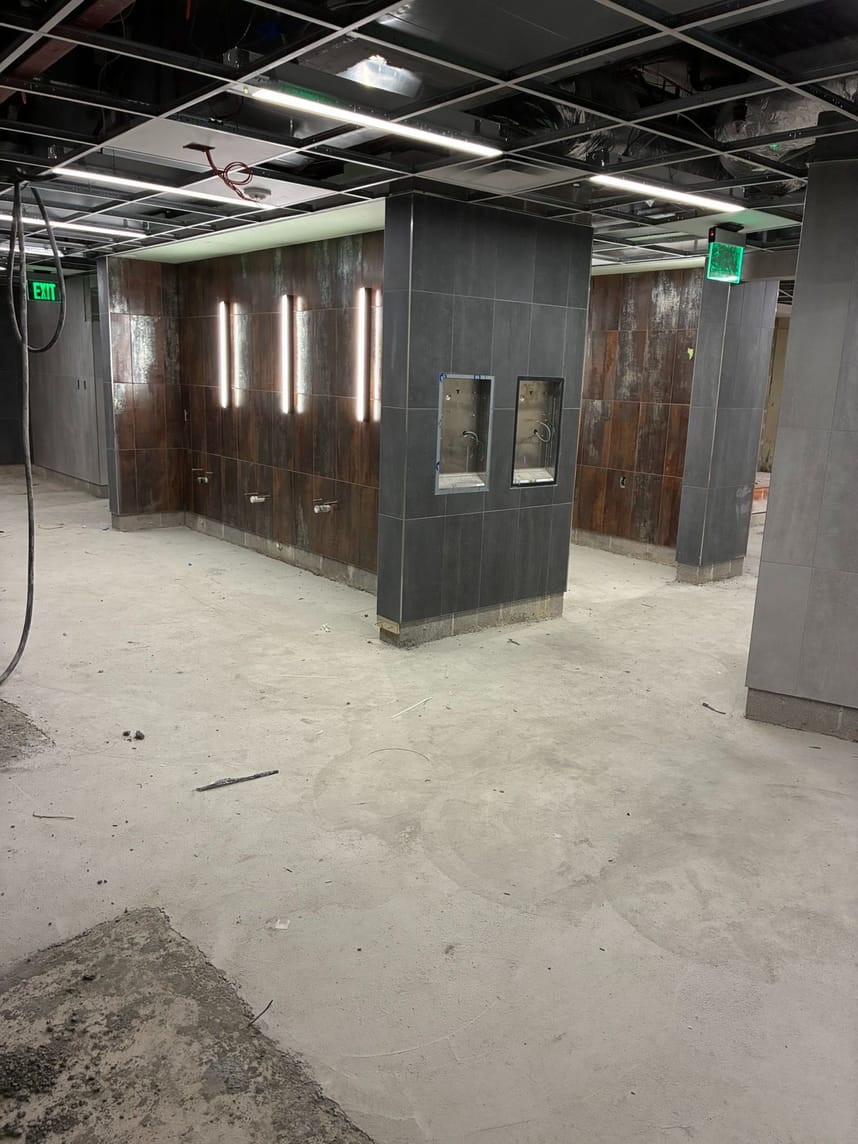empty locker room ready for sink and toilet installation