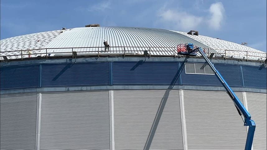 Workers on the burton Coliseum roof