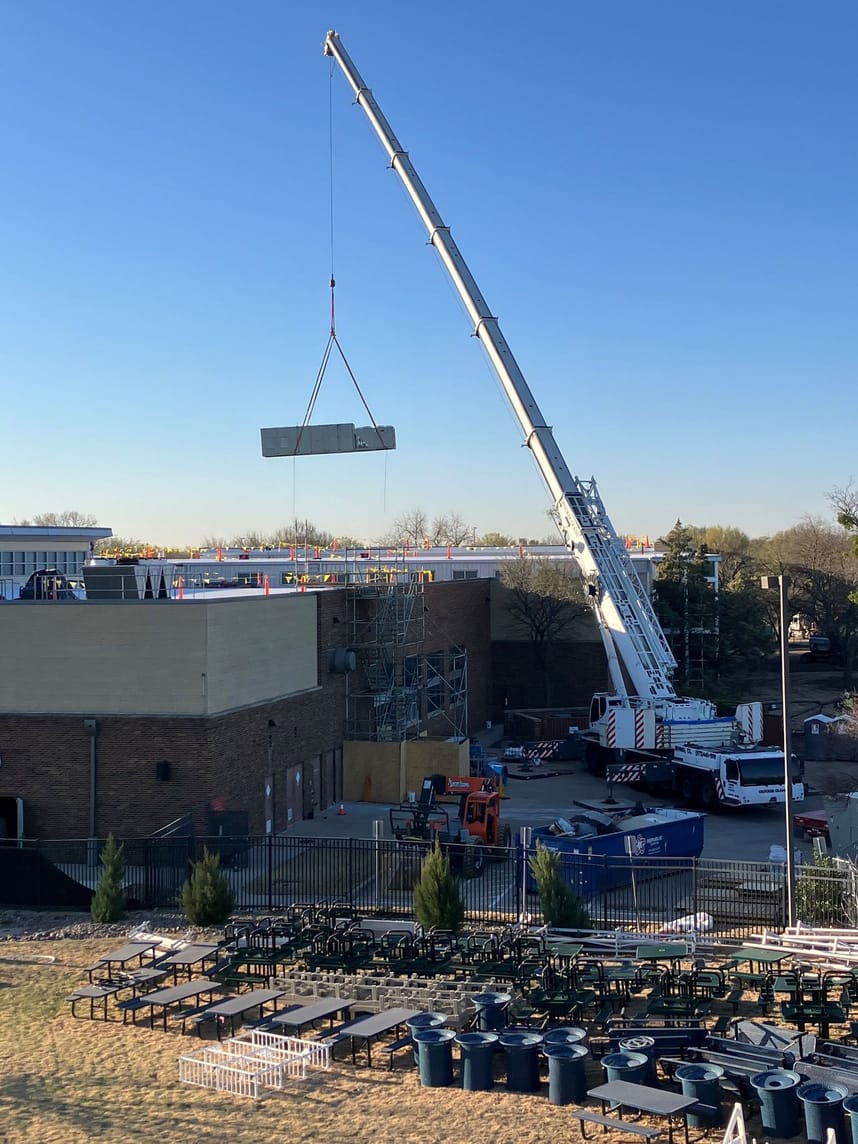 crane removing old hvac units from building