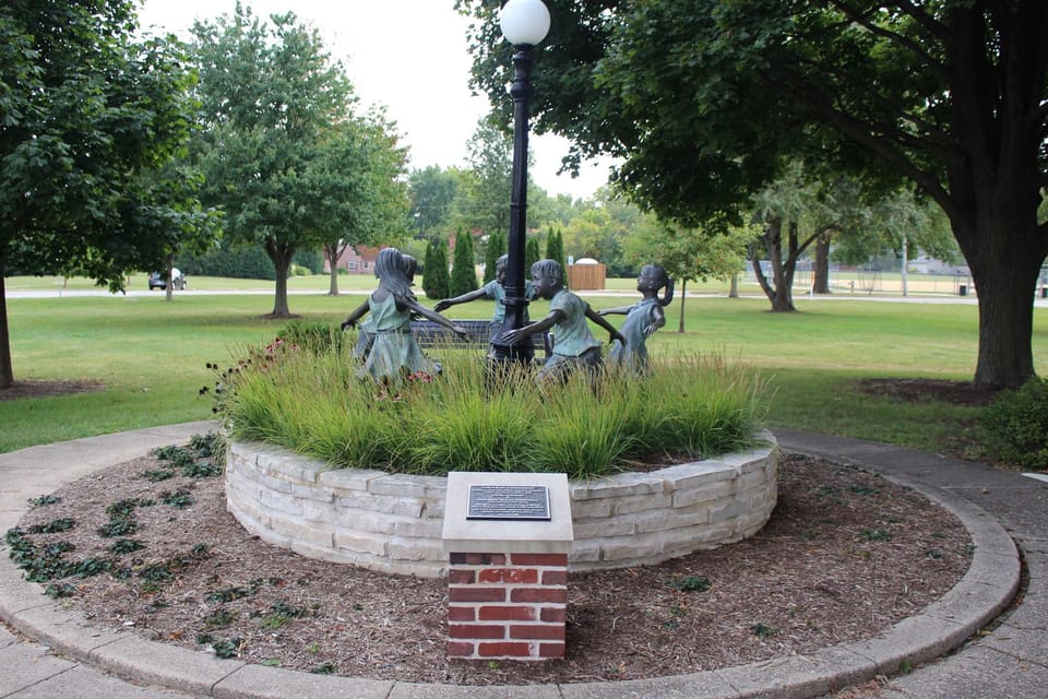 Sculpture of children playing ring around the rosy in a "Circle of Friendship."