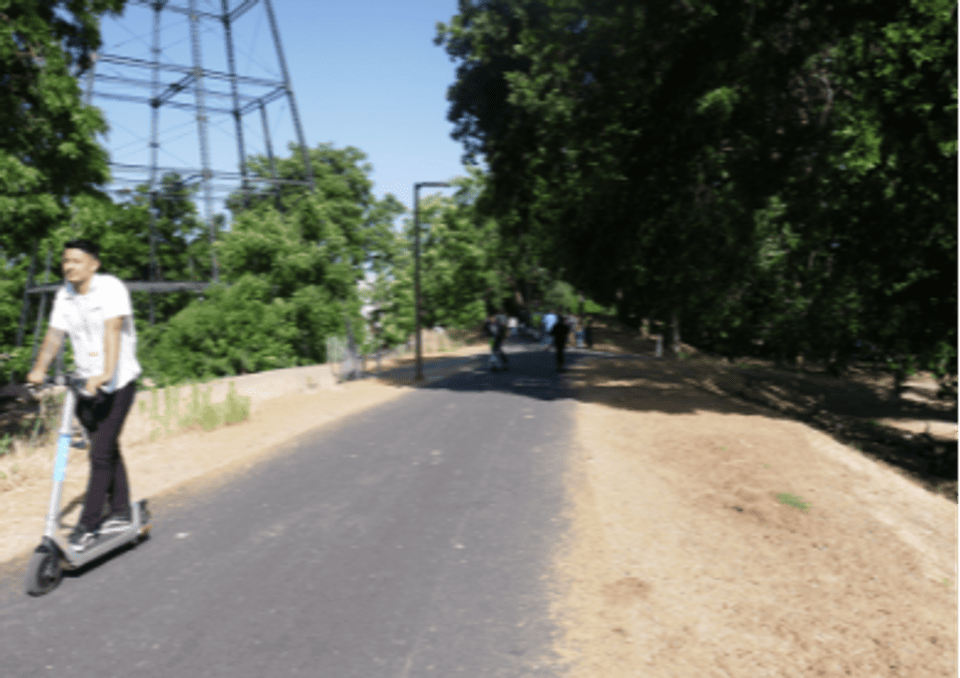 Person riding a scooter on new Riverwalk Trail