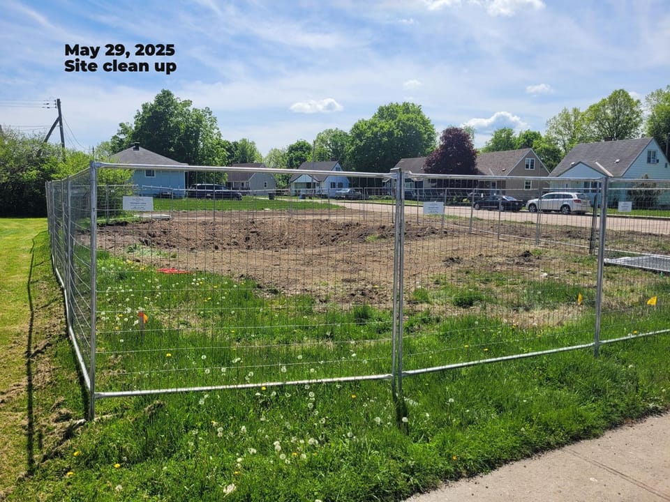 Fence around property, hole in the middle where basement was located