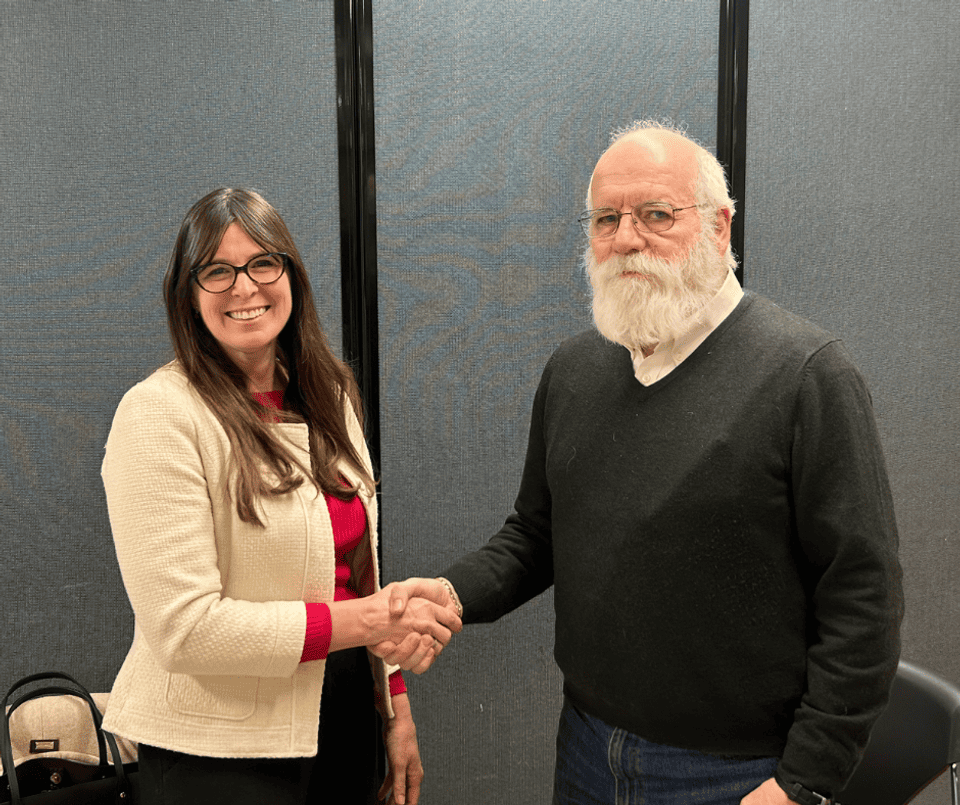 Kelly McNicholas Kury (left) shakes hands with Mayor Jack McCullough (right)