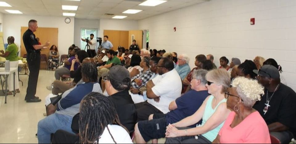 Photo of group of people sitting in chairs at the Scarboro Community Center for the Community Meeting with ORPD, NAACP, City of Oak Ridge, and local faith leaders