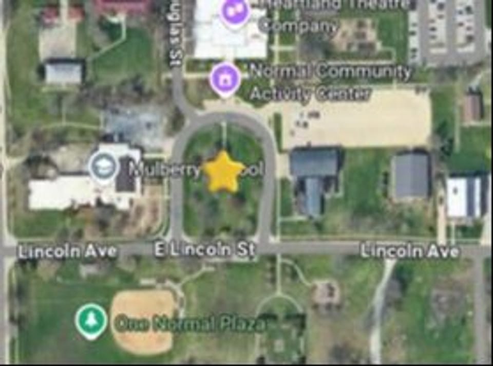 This map shows the planned Sculpture Garden location, identified by the yellow star (⭐). The sculpture park will be in the green space at the center of the circle drive for the Town of Normal Community Activity Center, 1110 Douglas Street, Normal. The circle drive is bounded by Lincoln Avenue to the south and the Community Activity Center to the north. 