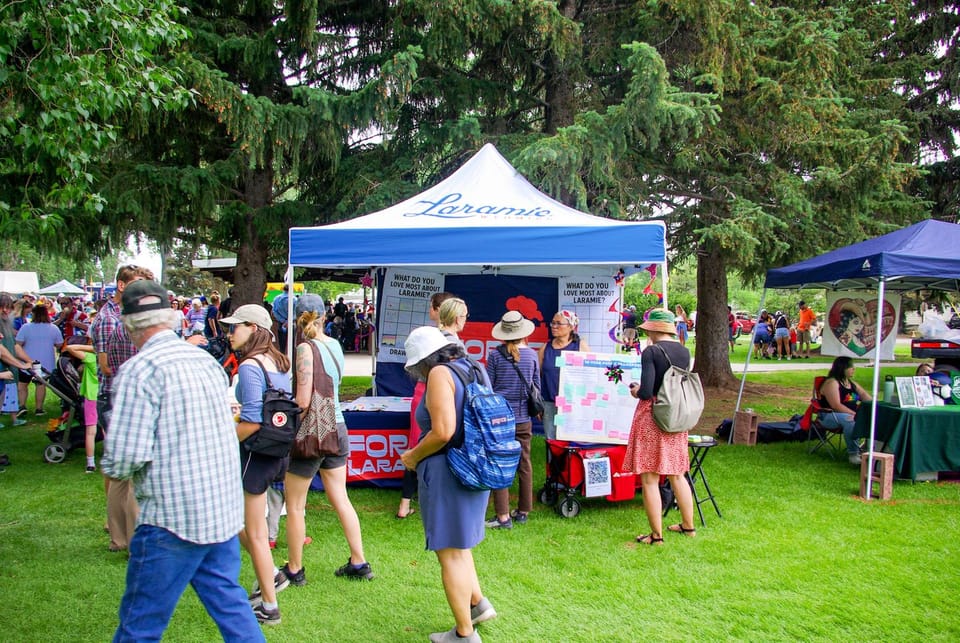 Image of City Staff Tabling with a bustling crowd at the annual Freedom Has A Birthday event in Washington Park.