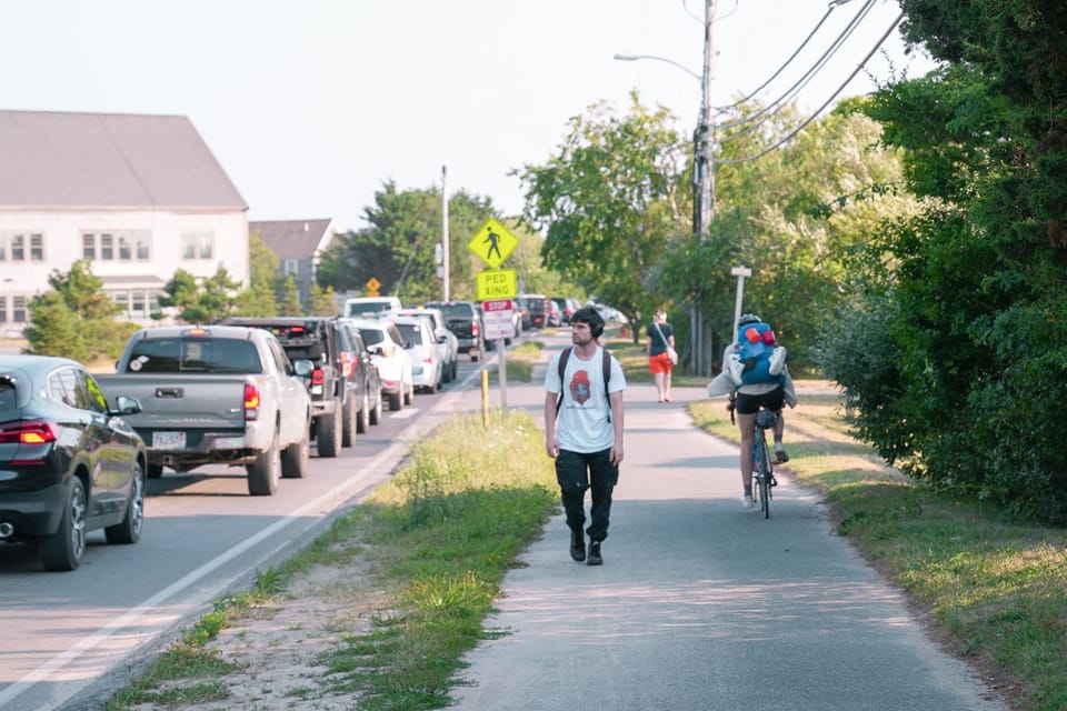 Traffic jam, person working, person riding a bike on Surfside Road