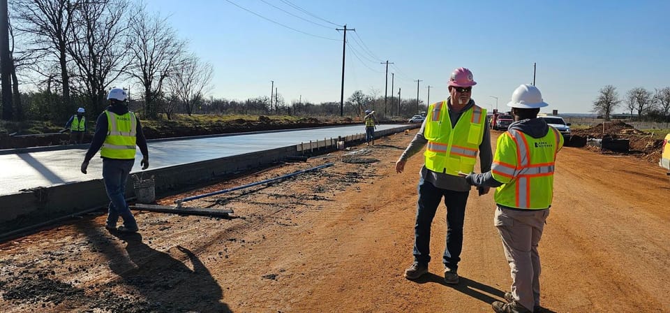 Construction workers paving lanes