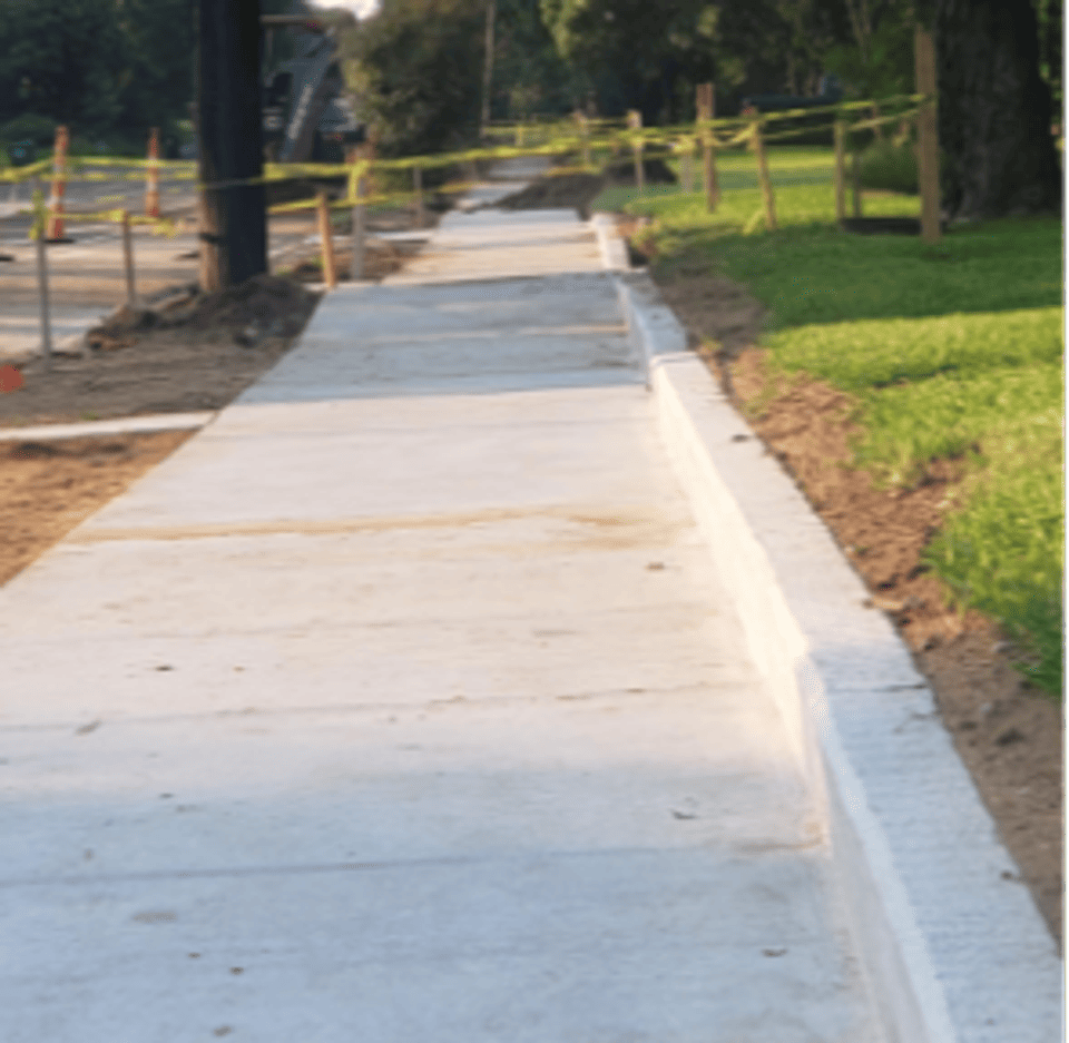 Graphic of a sidewalk with caution tape for paving being done