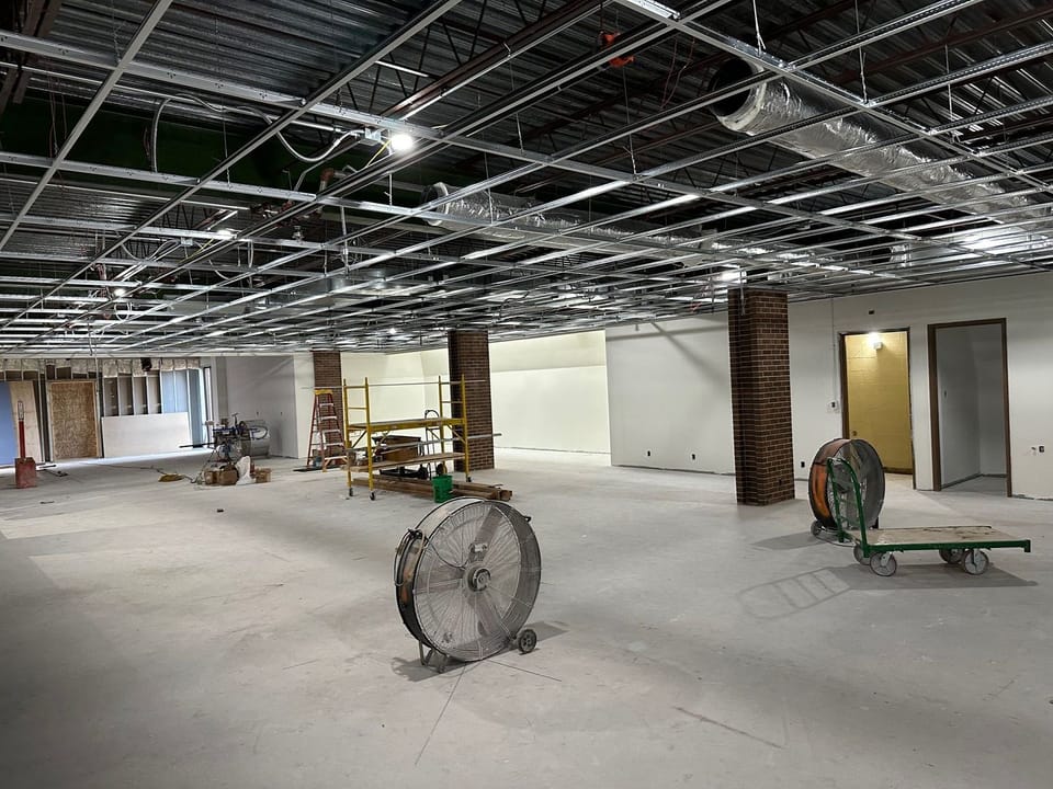Second floor of library, showing ceiling grid in place and walls primed & taped. 