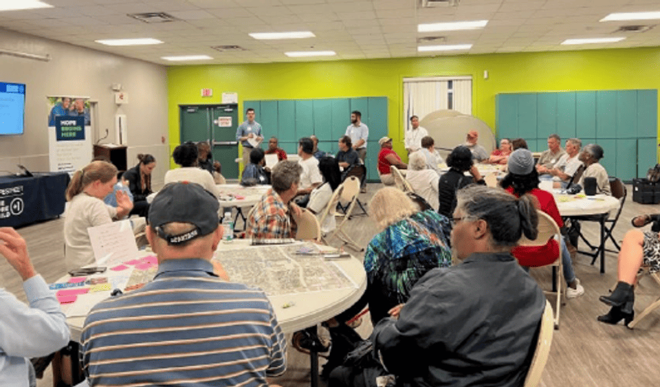 Photo of Sulphur Springs residents gathered at tables during the June 21, 2023 community meeting. 