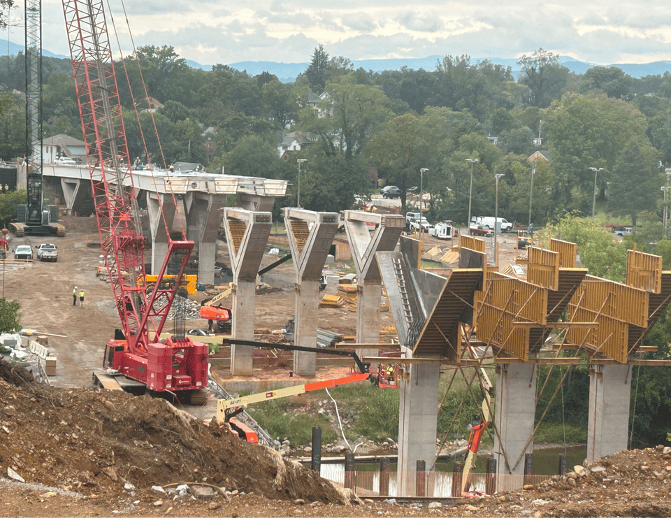Construction of the new Wasena Bridge showing bridge support piers and cranes.