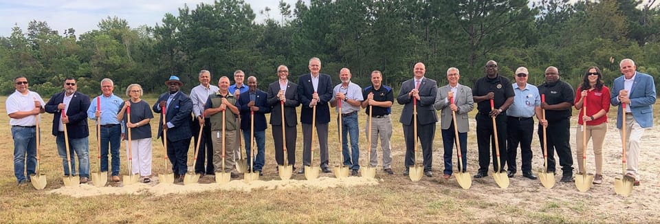 elected officials and staff hold shovels