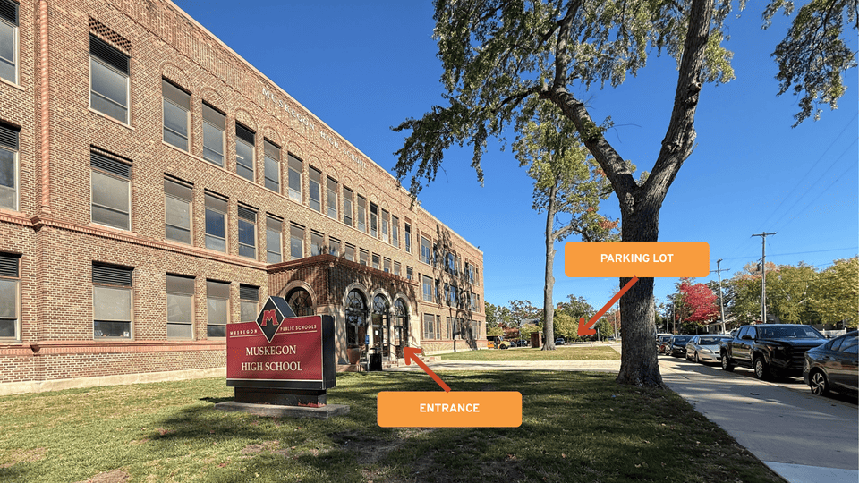 Muskegon High School entrance with arrows of where to enter and where to park