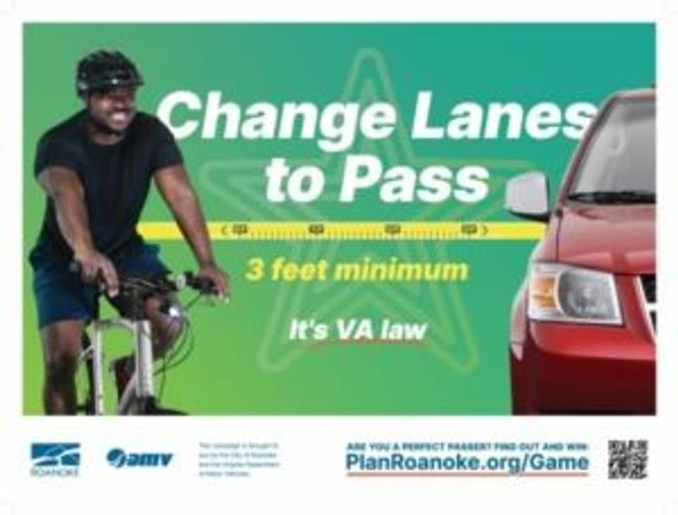 Image shows a man on a bike on the left side, and a red car on the right, separated by a ruler measuring 3 feet with the text "Change Lanes to Pass, 3 feet minimum, it's VA law."