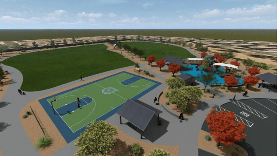 An image from above looking to the east showing the edge of parking, basketball court, play ground, and turf areas.