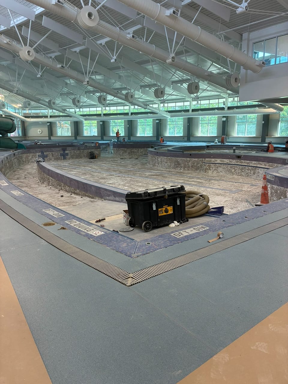 indoor pool with no water surrounded by new deck