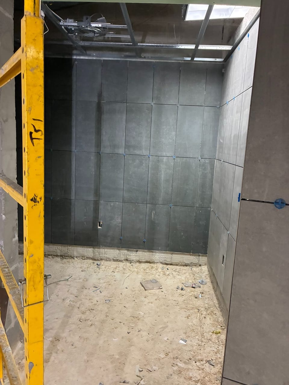 wall tiles being installed in locker room