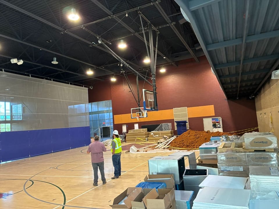 gymnasium court with new equipment ready to be installed
